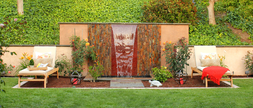 Design ideas for a contemporary garden wall in Orange County with a water feature.