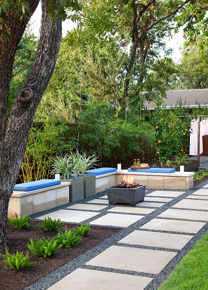 На фото: участок и сад в современном стиле с местом для костра, полуденной тенью и мощением тротуарной плиткой