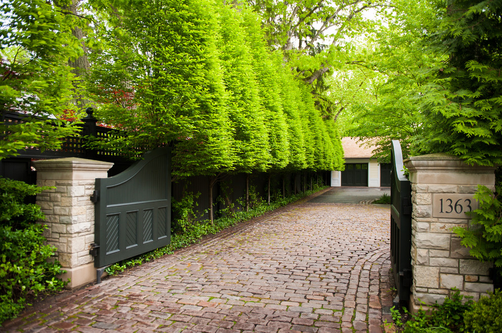 Inspiration for a traditional partial sun front yard brick landscaping in Chicago for summer.