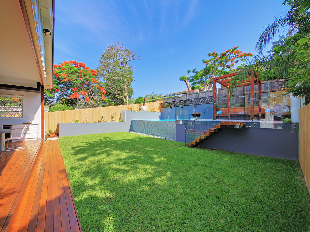 Photo of a medium sized contemporary back partial sun garden for summer in Brisbane with decking.