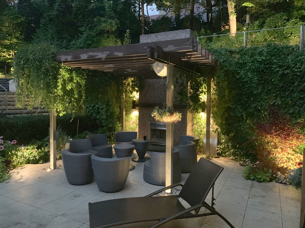 Design ideas for a large modern back patio in Toronto with a living wall and concrete paving.
