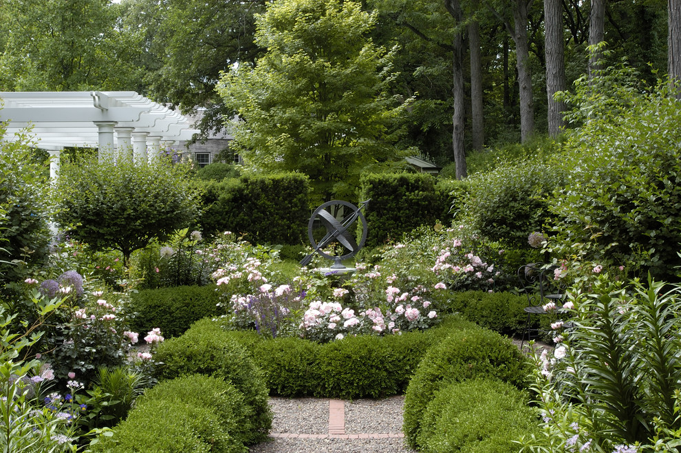 Design ideas for a mid-sized traditional partial sun backyard gravel formal garden in Chicago for summer.