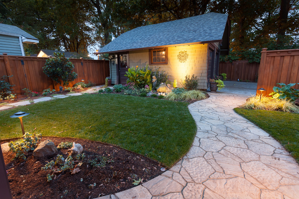 This is an example of a medium sized traditional back formal partial sun garden for summer in Portland with a water feature and concrete paving.