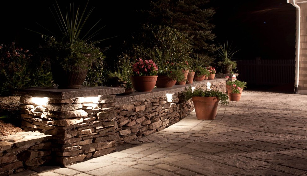 This is an example of a traditional full sun side yard concrete paver landscaping in Philadelphia.