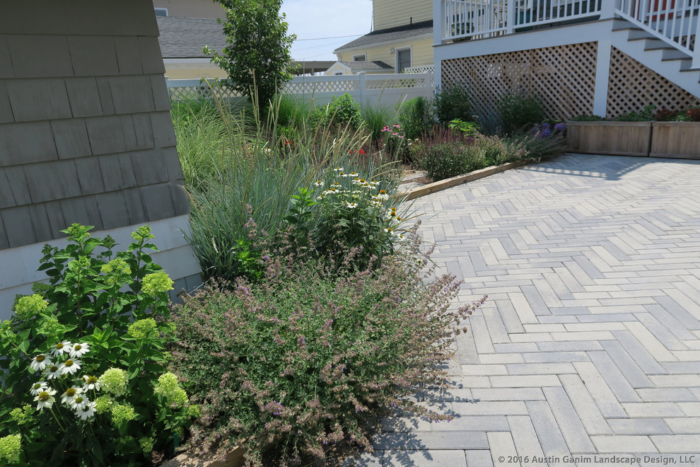 Photo of a coastal full sun front yard concrete paver driveway in Bridgeport for summer.