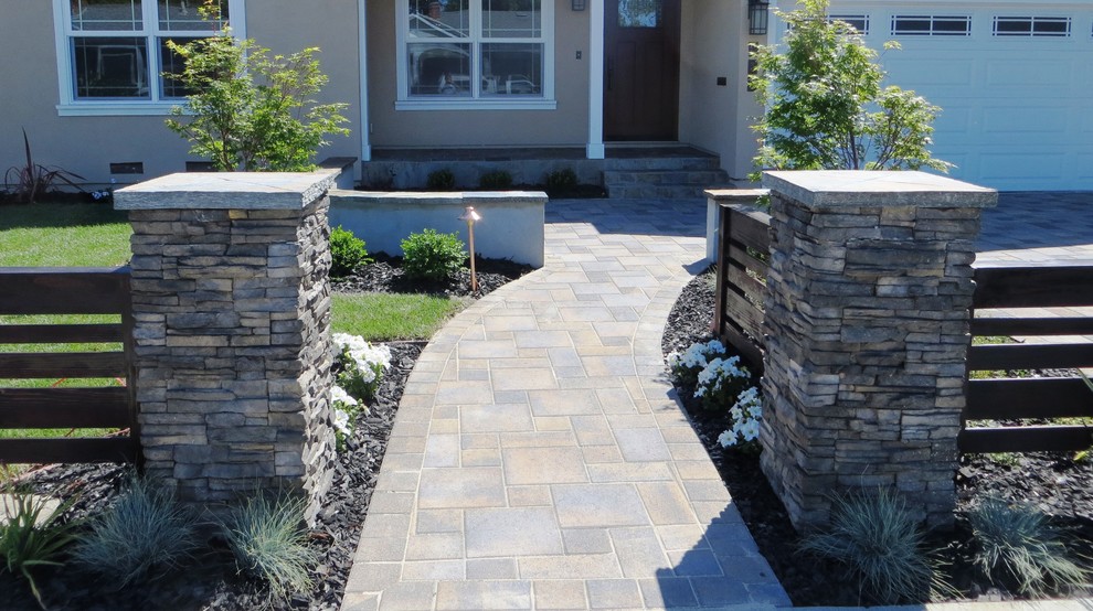 Photo of a large traditional front yard concrete paver driveway in San Francisco.