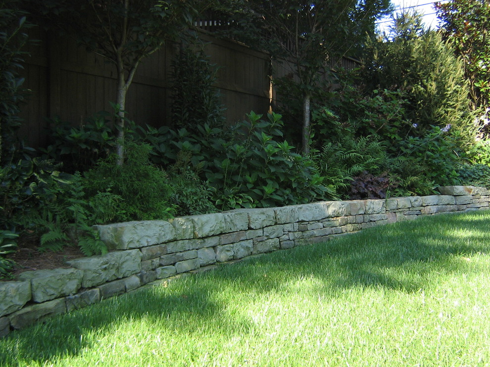 Idee per un grande giardino classico esposto a mezz'ombra dietro casa con un muro di contenimento