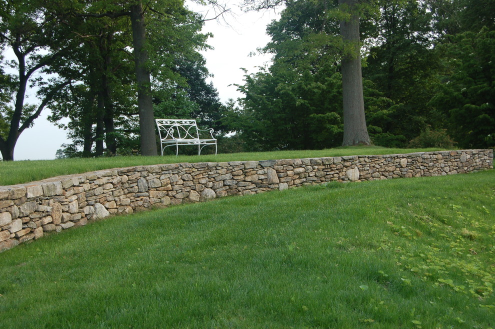 Design ideas for a mid-sized traditional full sun backyard stone retaining wall landscape in Boston for summer.