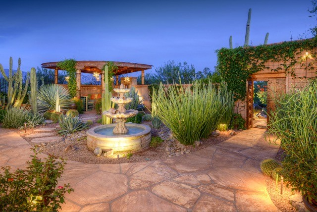 Photo of a medium sized traditional back full sun garden in Phoenix with a water feature and natural stone paving.