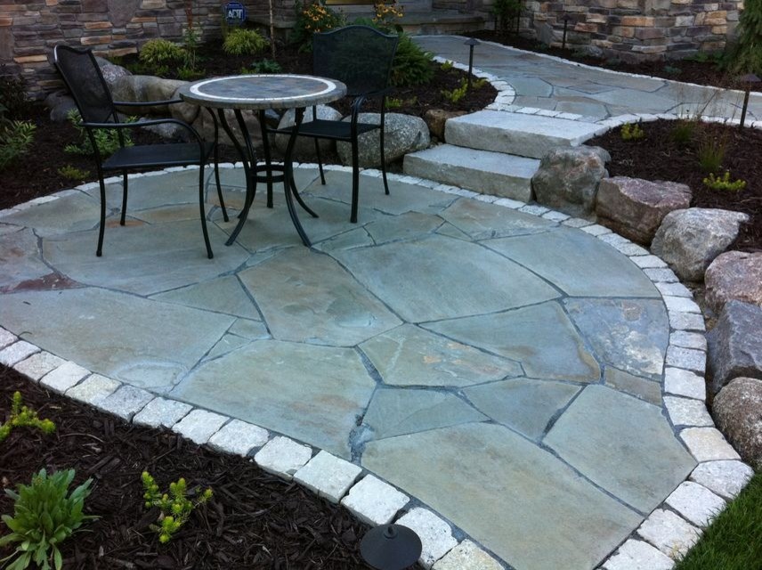 This is an example of a mid-sized traditional courtyard stone garden path in Minneapolis.