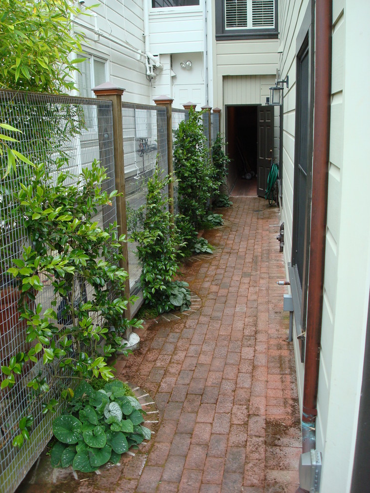 Esempio di un piccolo giardino eclettico esposto a mezz'ombra dietro casa in estate con pavimentazioni in mattoni