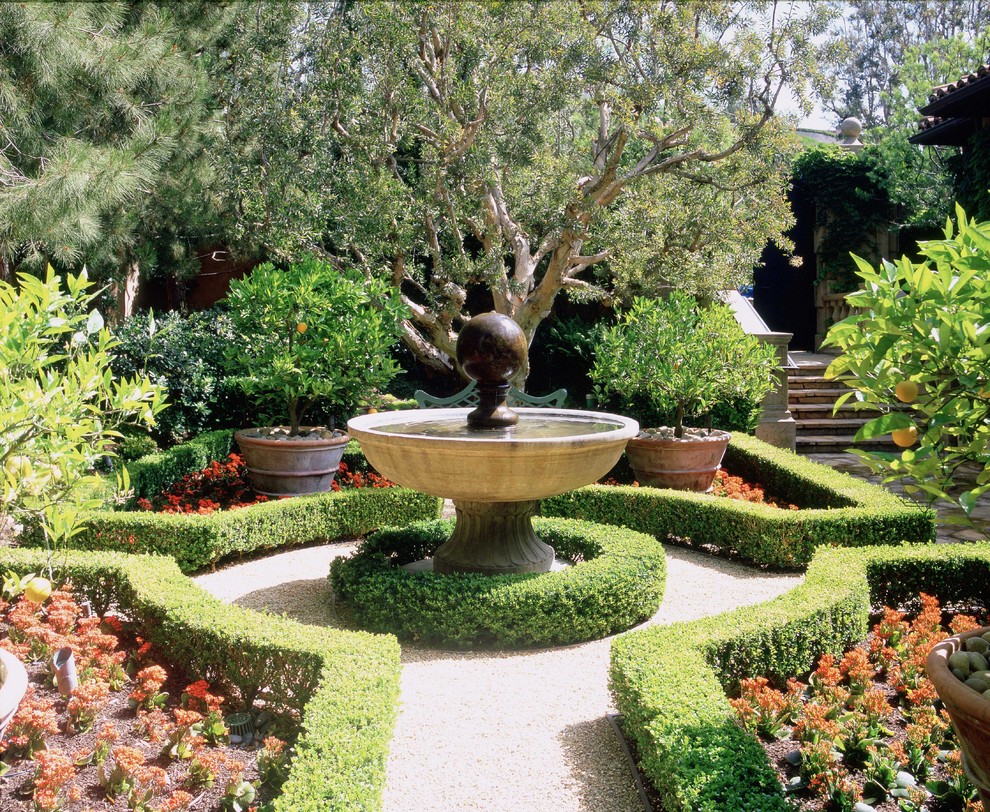 This is an example of a small traditional formal garden steps in Orange County with gravel.