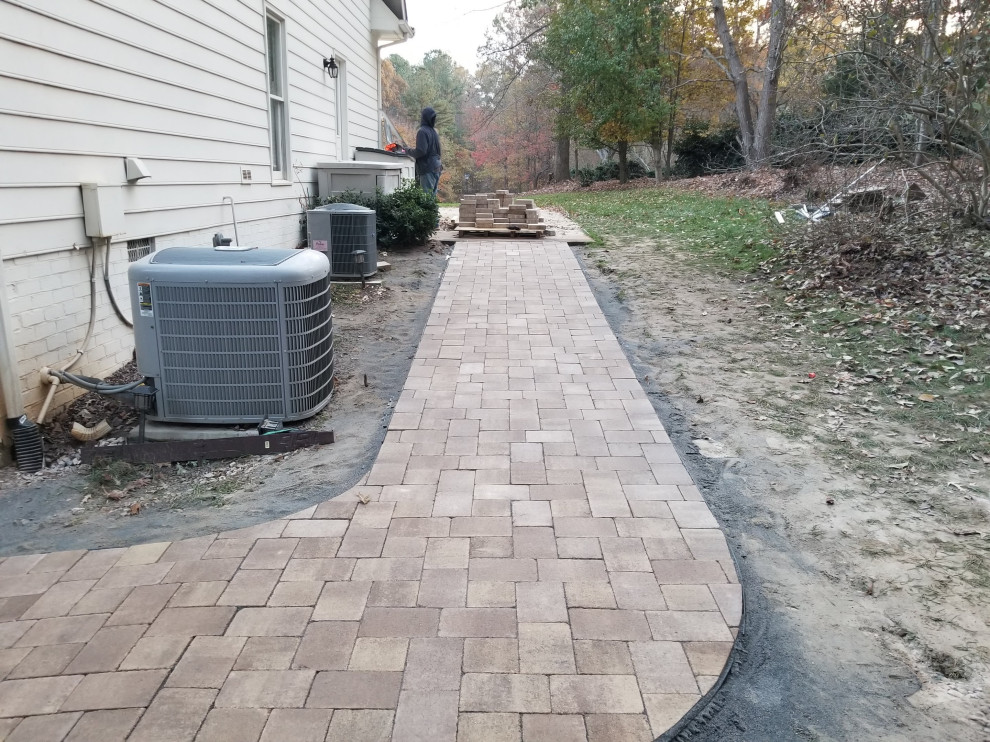 This is an example of a medium sized traditional back garden in Raleigh with a pathway and concrete paving.