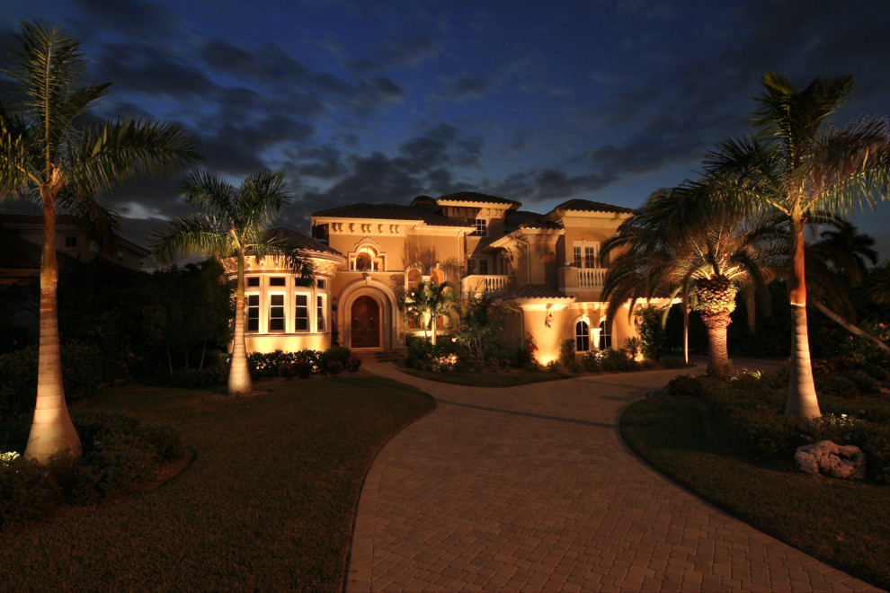 Inspiration for a large world-inspired front driveway garden in Jacksonville with concrete paving.