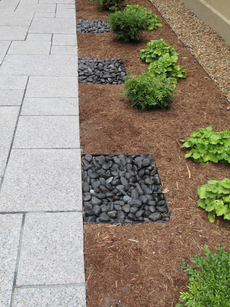 This is an example of a small asian full sun front yard stone landscaping in Boston.