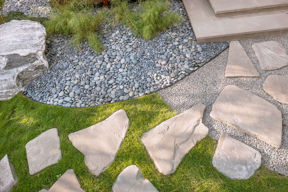 This is an example of a mid-sized asian partial sun side yard stone garden path in Houston.
