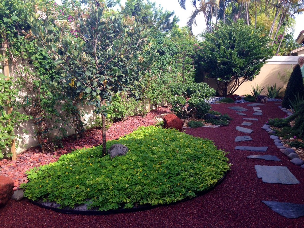 Inspiration for a mid-sized asian partial sun backyard stone landscaping in Miami.