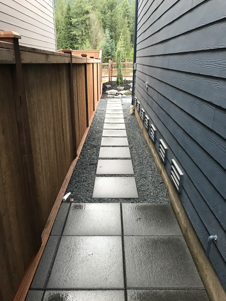 This is an example of a small asian partial sun backyard concrete paver landscaping in Seattle.