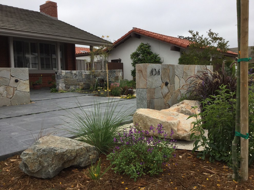 Design ideas for a mid-sized asian front yard stone landscaping in San Diego.