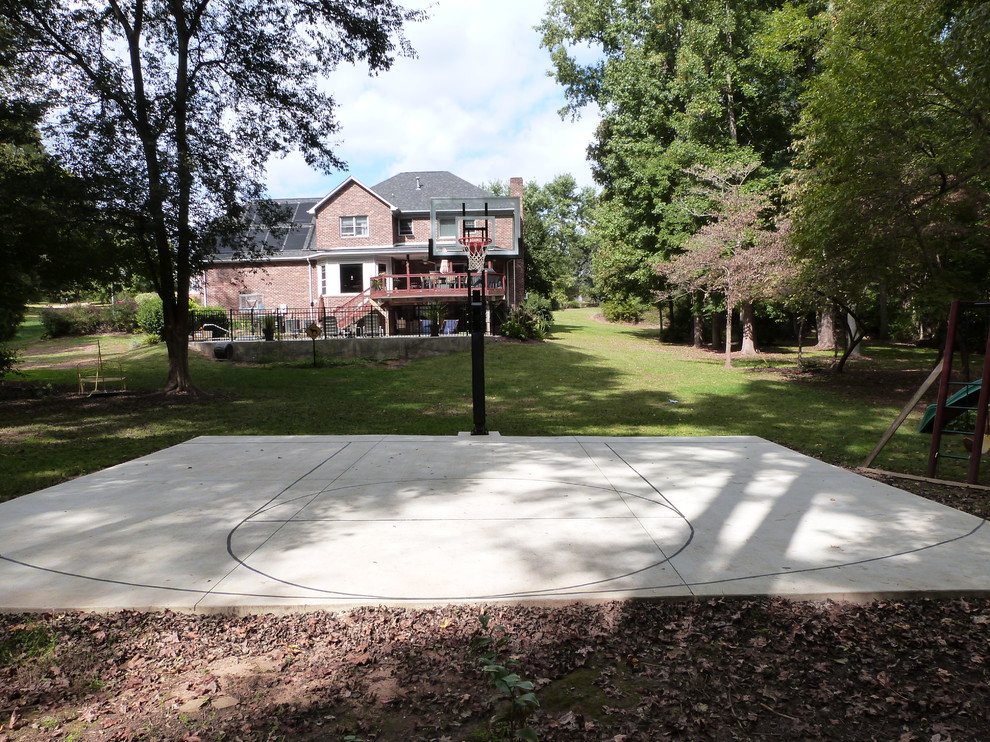 This is an example of a large traditional partial sun backyard outdoor sport court in Charlotte.