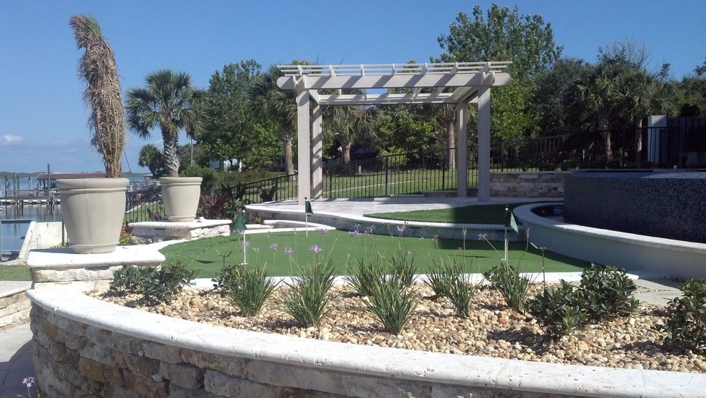 Large classic back partial sun garden for summer in Orlando with an outdoor sport court, a water feature and brick paving.