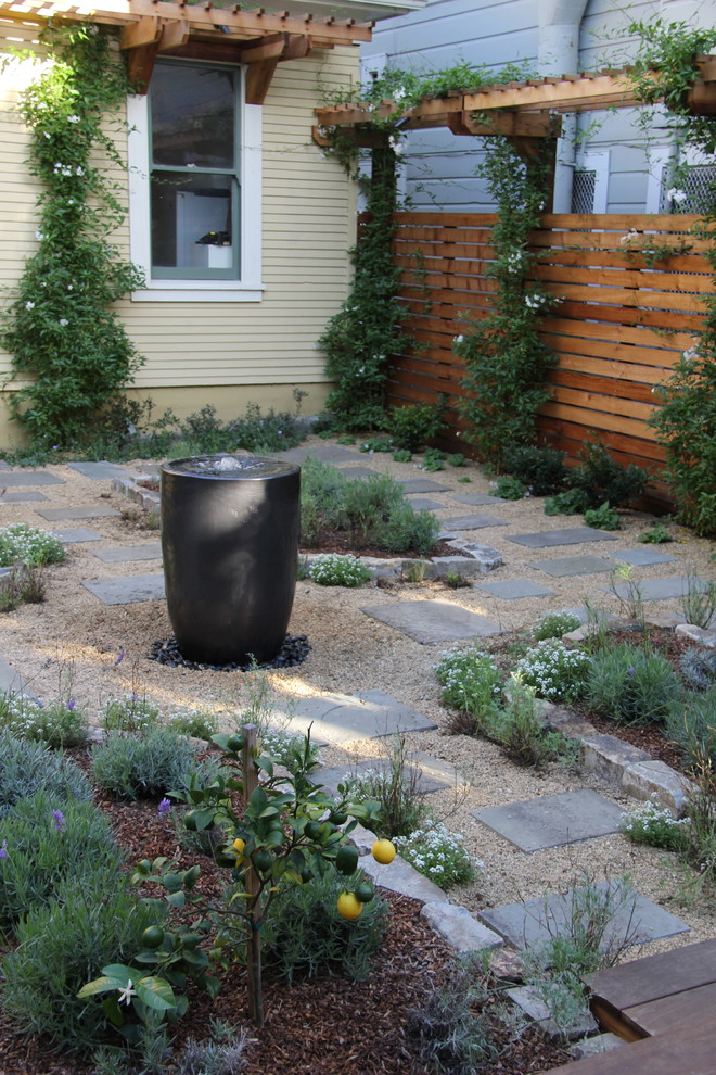 This is an example of a medium sized classic back full sun garden in San Francisco with natural stone paving.