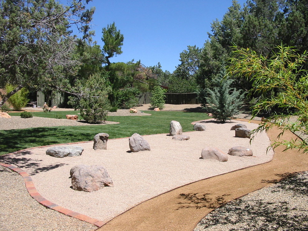 World-inspired back garden in Phoenix with a garden path.