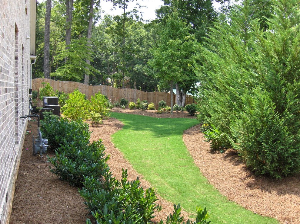 Photo of a large traditional partial sun backyard mulch landscaping in Atlanta with a fire pit for summer.