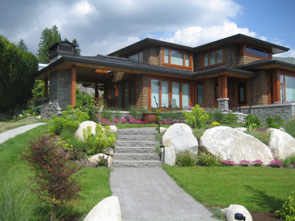 Photo of a large contemporary full sun front yard stone landscaping in Vancouver.
