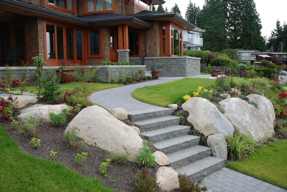 Inspiration for a large contemporary full sun front yard stone landscaping in Vancouver.