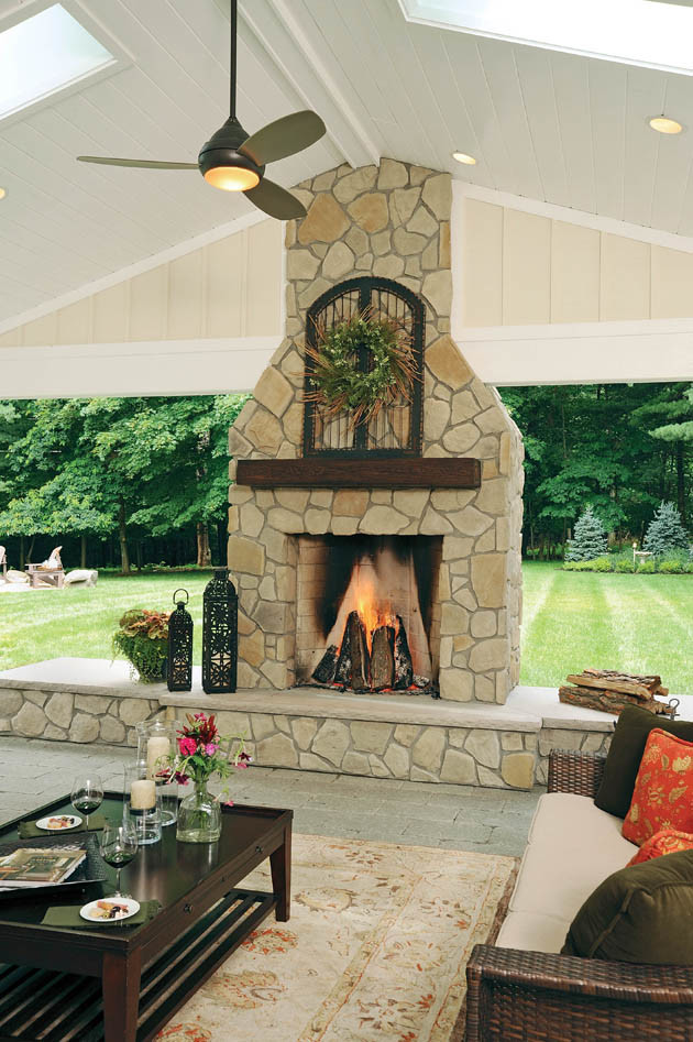 Inspiration for a huge traditional full sun backyard brick landscaping in Columbus with a fire pit for fall.
