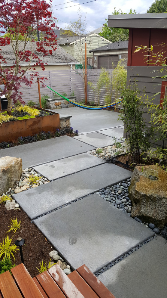 Idee per un orto rialzato design esposto in pieno sole dietro casa in autunno con pavimentazioni in cemento e recinzione in legno