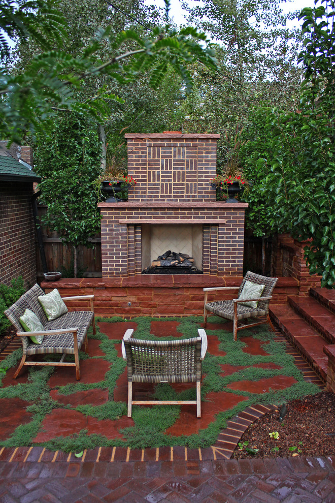 Example of a classic backyard stone patio design in Denver
