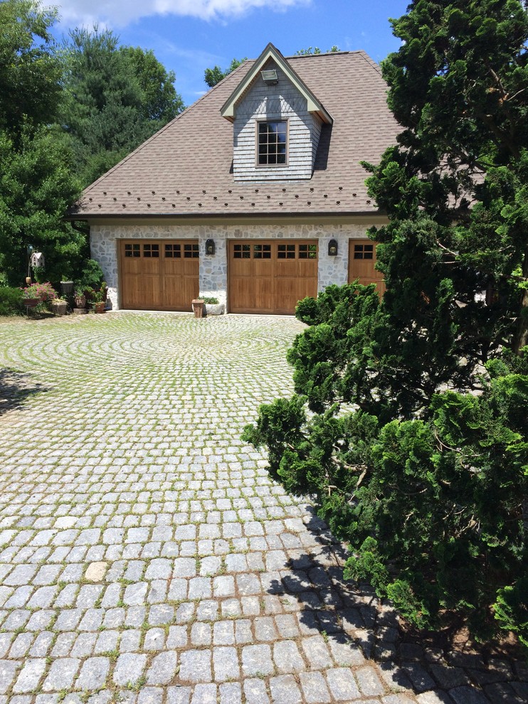 Inspiration for a large classic front driveway partial sun garden in Baltimore with brick paving.