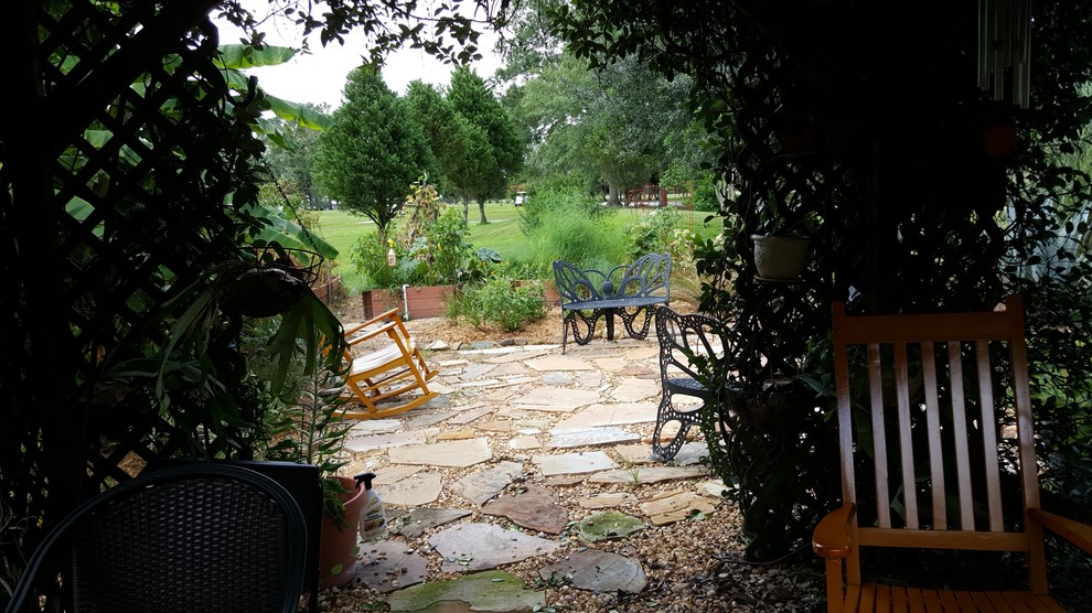 Foto de jardín clásico de tamaño medio en patio delantero con fuente, exposición total al sol y adoquines de piedra natural