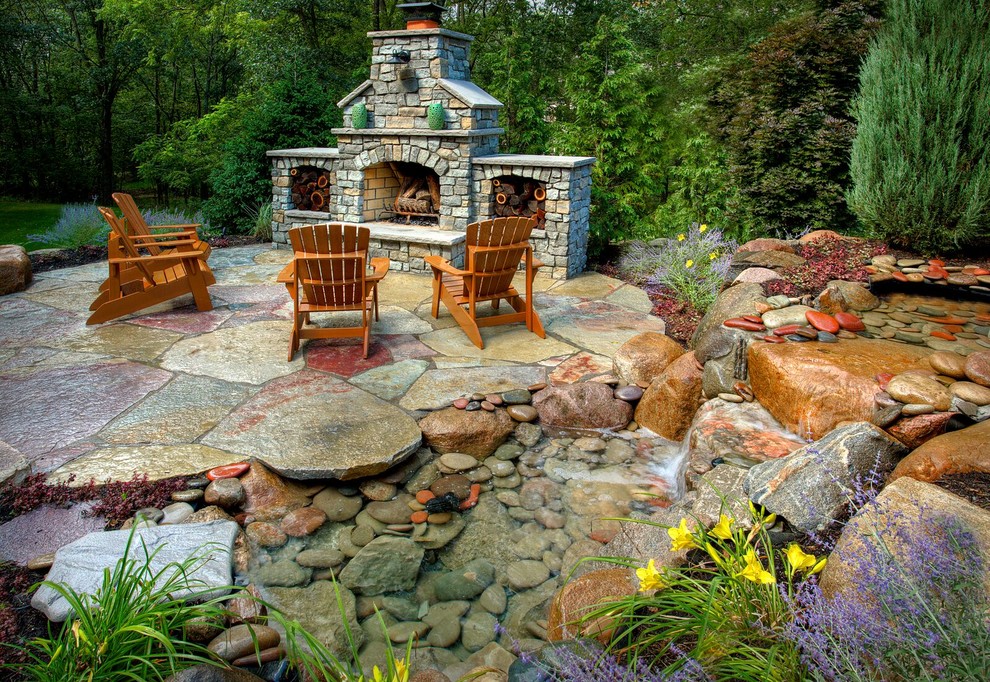 Photo of a classic back garden in Orange County with a fire feature and natural stone paving.