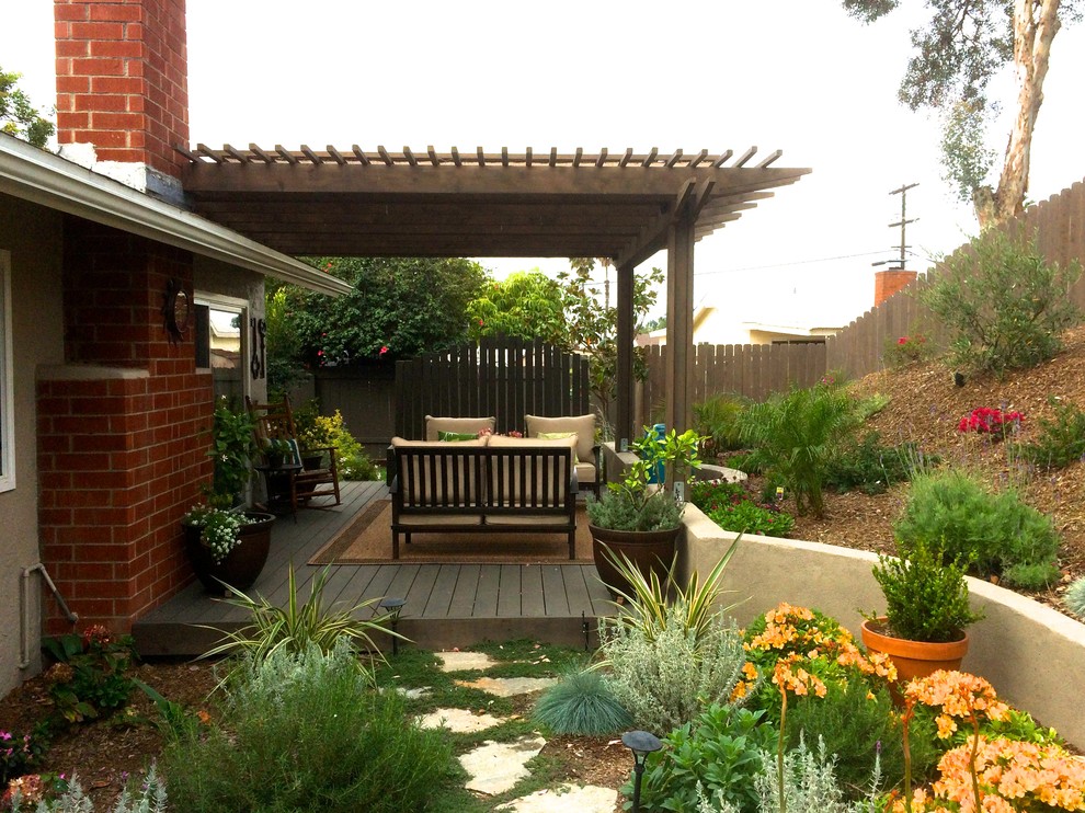 Design ideas for a mediterranean garden in San Diego with a retaining wall and decking.