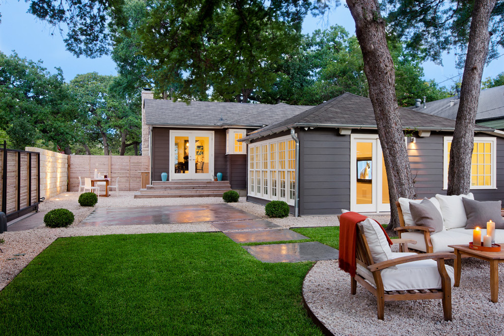 This is an example of a transitional backyard gravel landscaping in Austin.