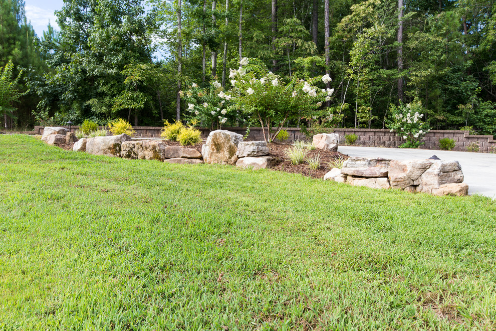 Inspiration for a mid-sized rustic full sun front yard stone driveway in Charlotte.