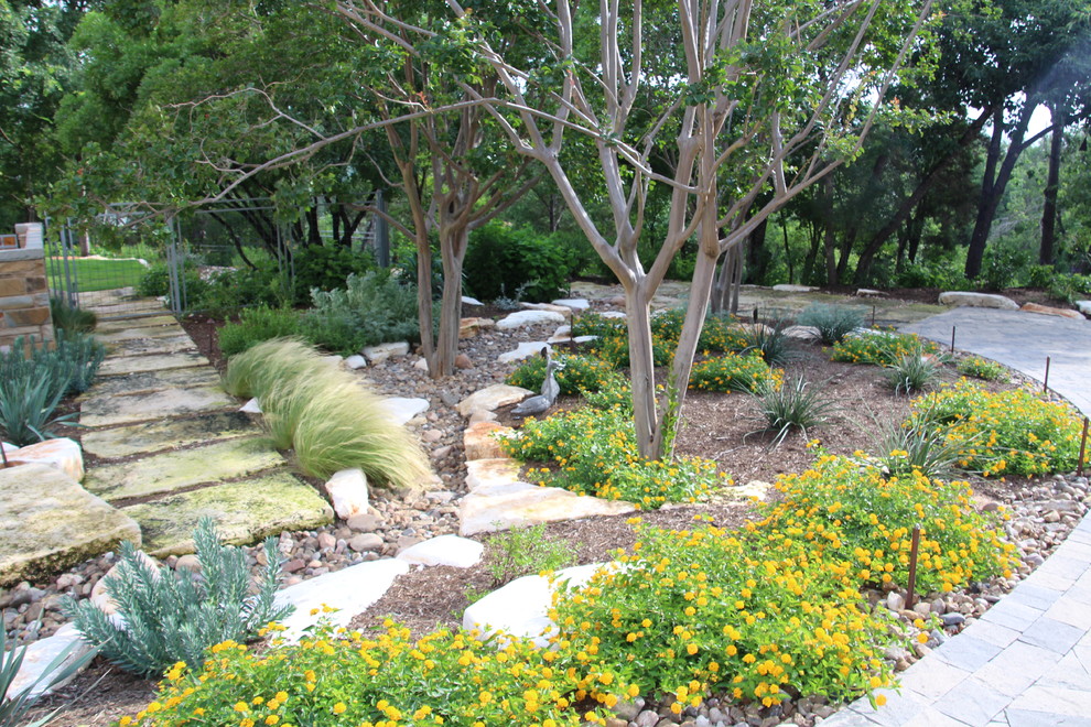 This is an example of a large contemporary drought-tolerant and partial sun side yard brick landscaping in Austin for summer.