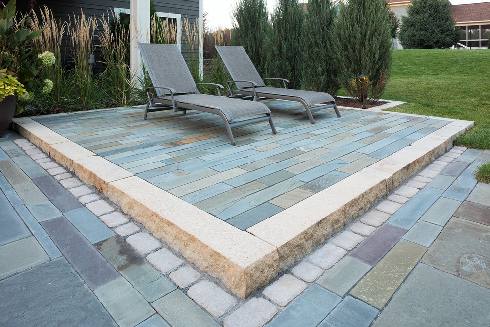 Photo of a medium sized contemporary back full sun garden in Minneapolis with a fire feature and concrete paving.