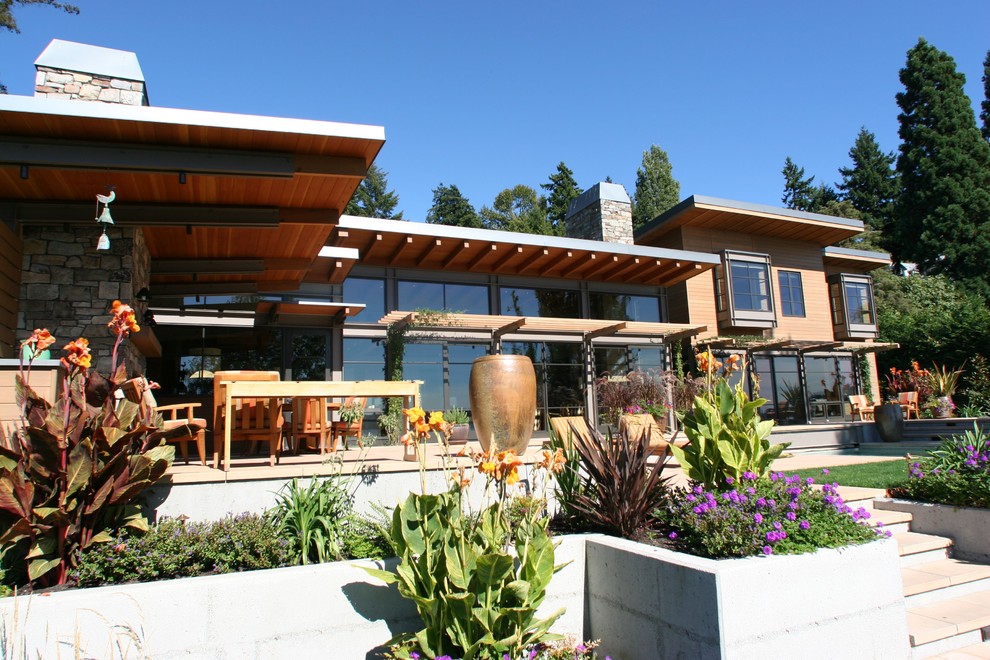 Design ideas for a large contemporary partial sun backyard concrete paver formal garden in Seattle for summer.