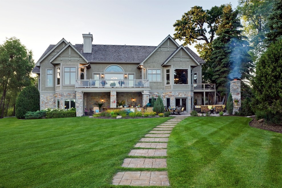 Inspiration for a large traditional partial sun backyard stone landscaping in Minneapolis with a fireplace for summer.