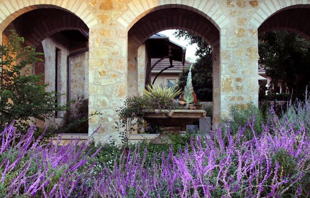 Design ideas for a large mediterranean back xeriscape full sun garden for summer in Austin with concrete paving.