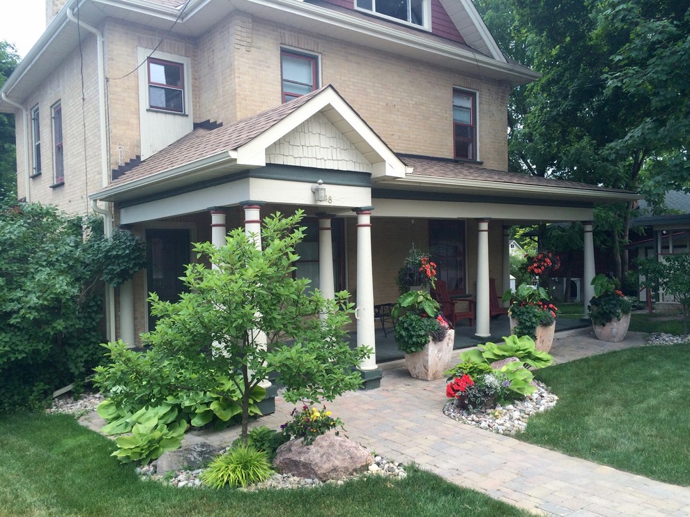 Lakefield, river rock garden and pavers entrance Craftsman