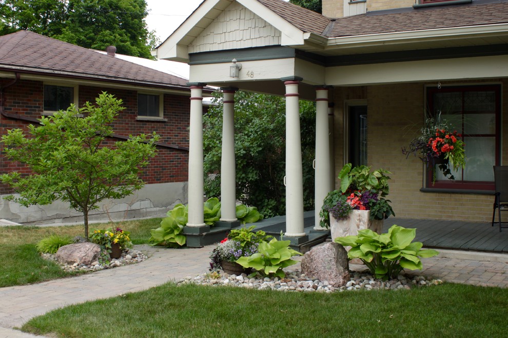 Lakefield, river rock garden and pavers entrance Craftsman