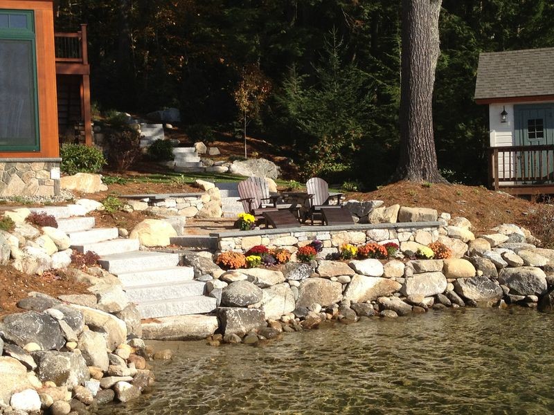 Photo of a mid-sized rustic full sun backyard stone landscaping in Manchester for summer.