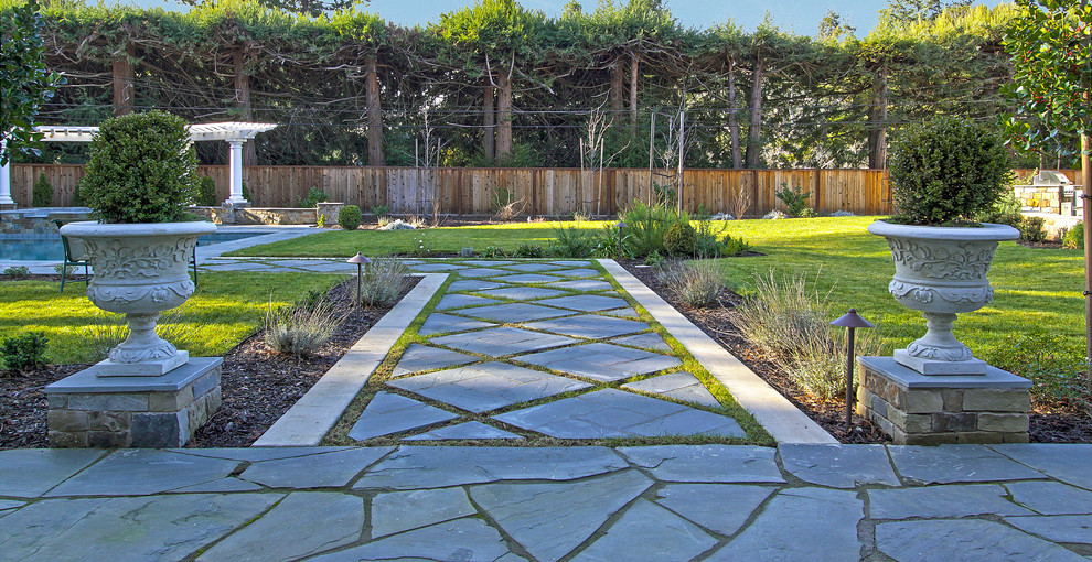 Inspiration for a mediterranean back garden in Other with natural stone paving.