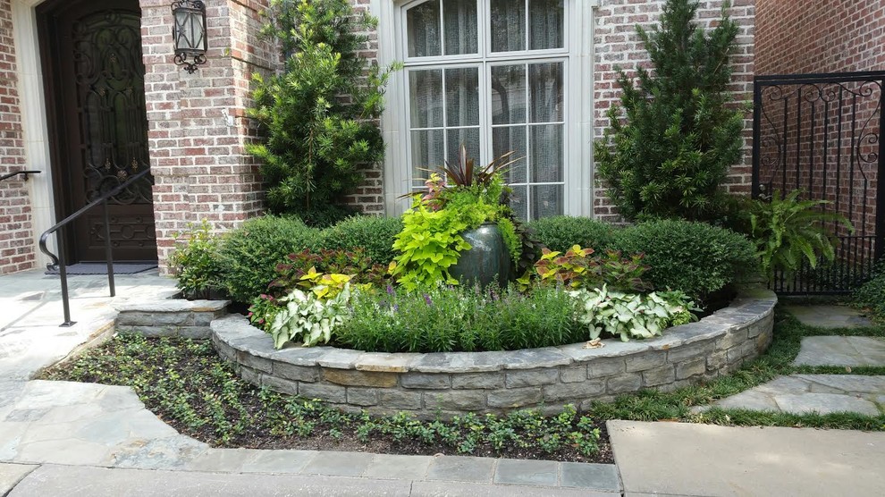 Inspiration for a mid-sized traditional front yard stone landscaping in Atlanta.