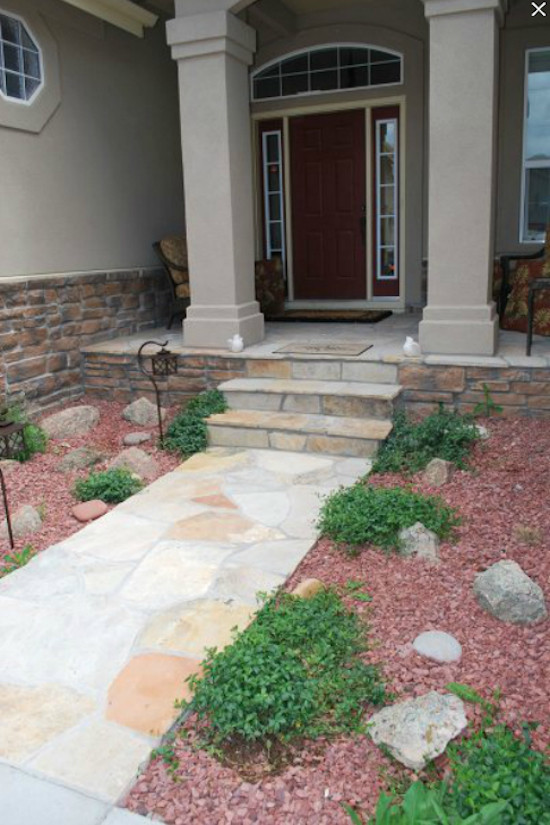 Inspiration for a large classic front partial sun garden in Denver with a potted garden and brick paving.